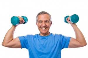 A senior man holding two dumbbells while flexing his muscles.