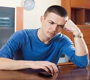 Ordinary guy at table in home