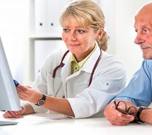 doctor talking to her male senior patient at office